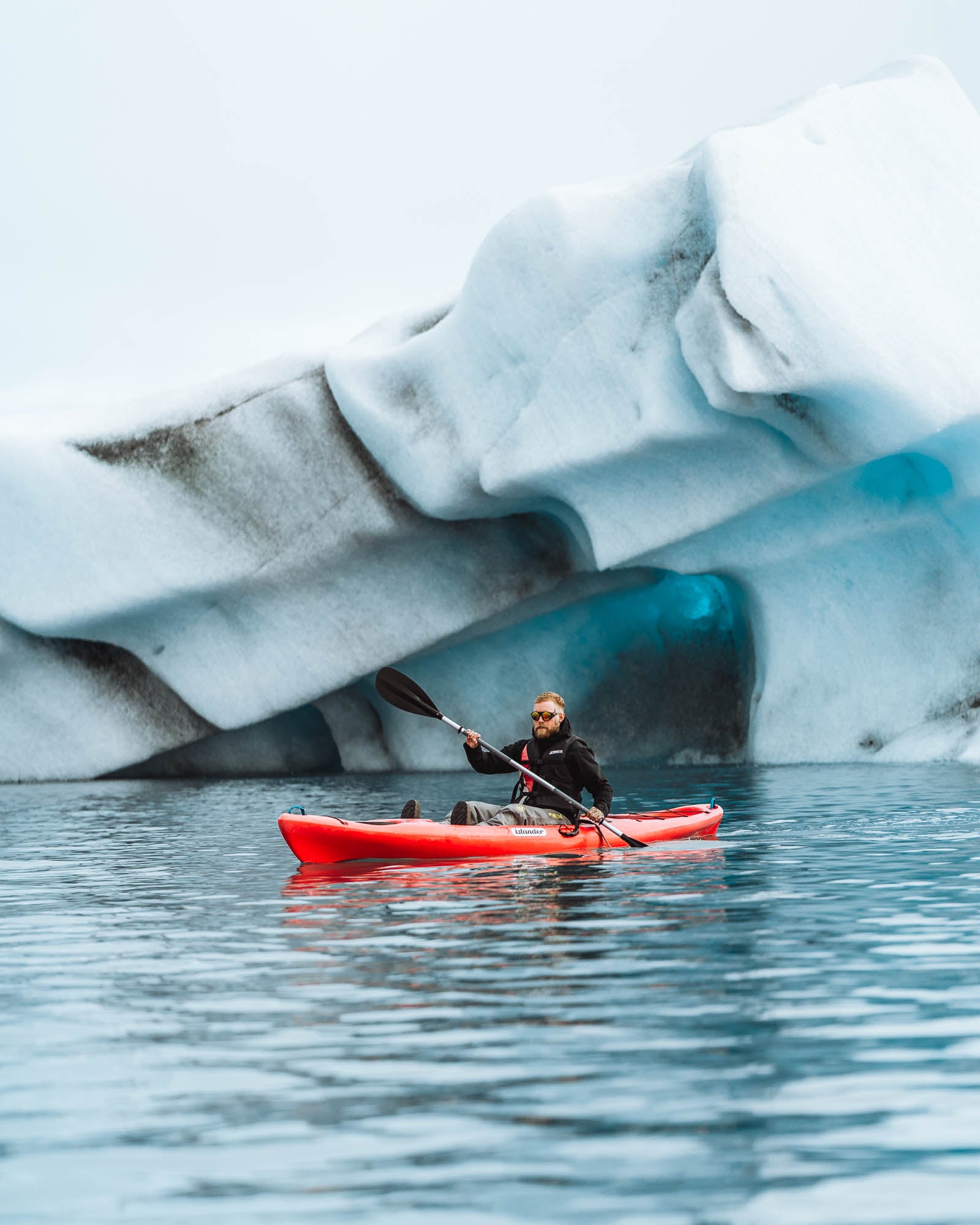 A kayaker in Jokulsarlon marvels over the ice.