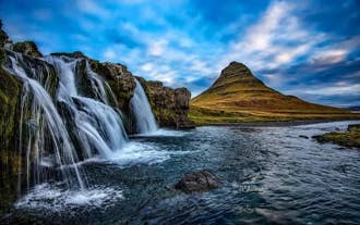 A photo of Mount Kirkjufell with Kirkjufellsfoss waterfall in the foreground.