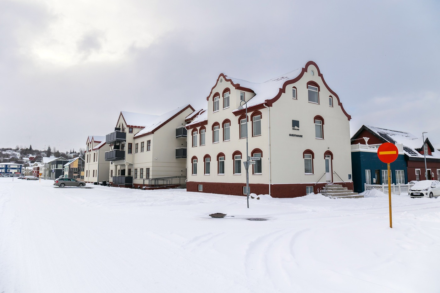 아쿠레이리(Akureyri)에 위치한 흐림란드 게스트하우스(Hrimland Guesthouse)의 빨간색과 흰색 외관, 눈 덮인 주변 풍경