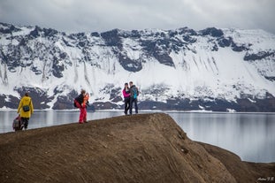 Travelers marvel over the lake at the Askja caldera.