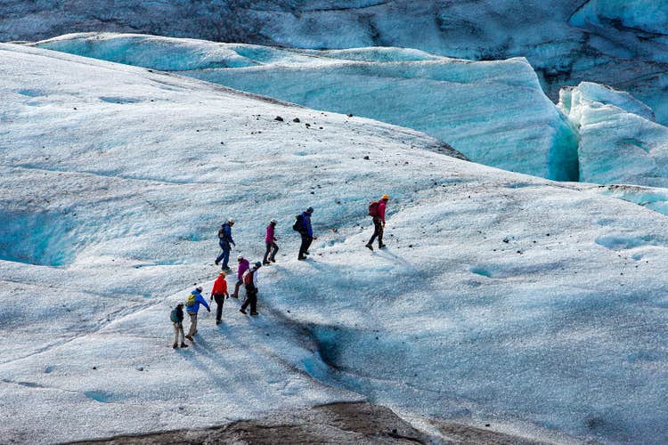 Adventurers hike through Skaftafell’s icy landscape in Vatnajokull National Park.