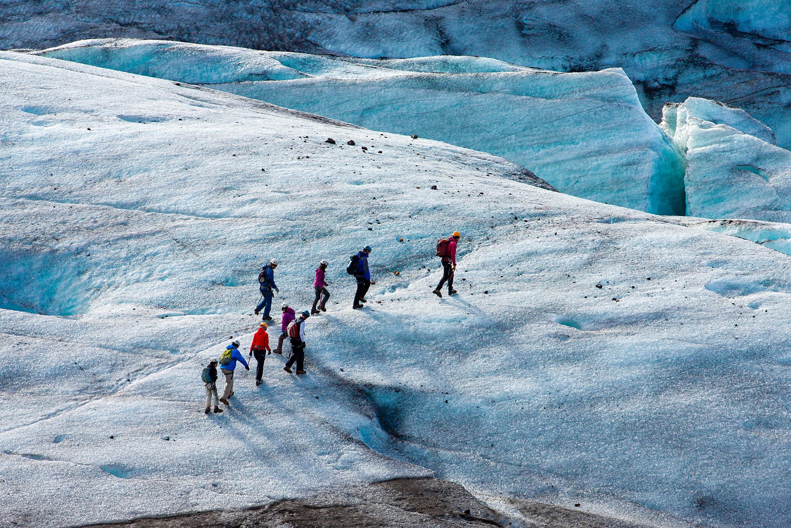 Adventurers hike through Skaftafell’s icy landscape in Vatnajokull National Park.