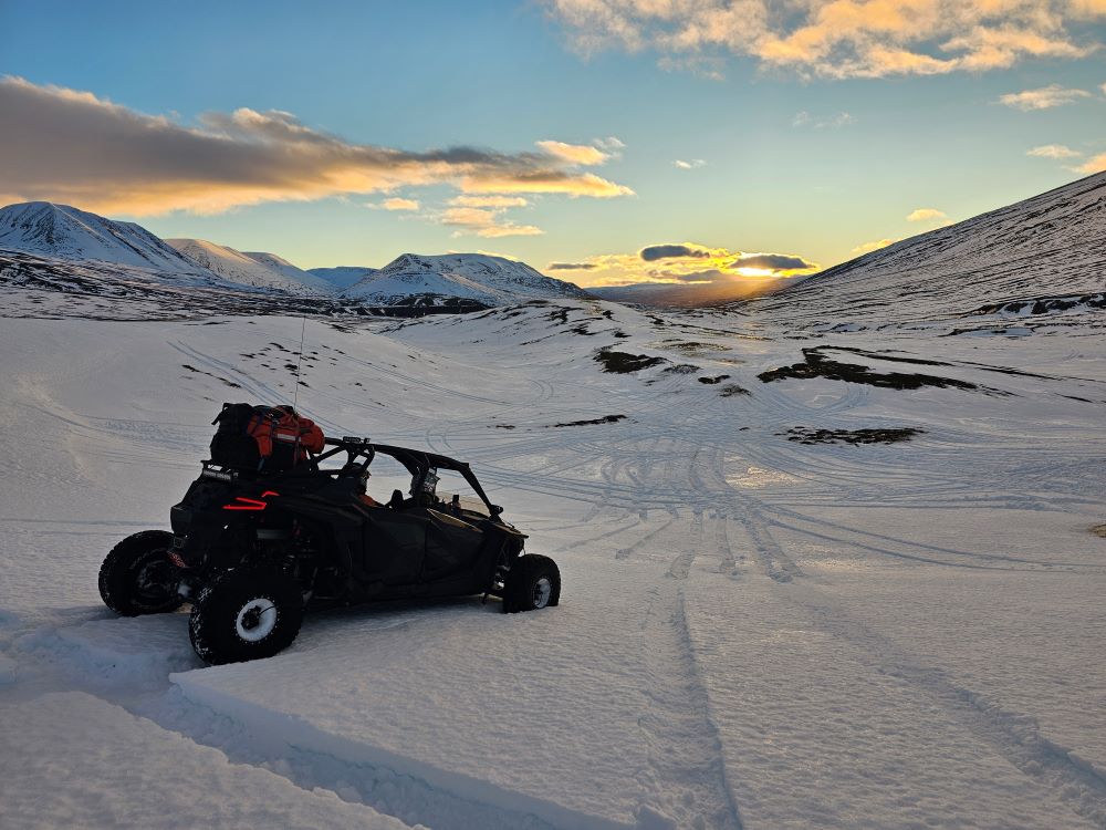 A buggy vehicle in Iceland traversing a snowy landscape near Reykjavik.