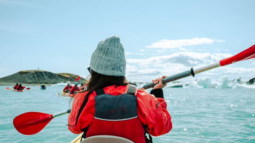 Kayakers paddle between icebergs in Jokulsarlon Glacier Lagoon