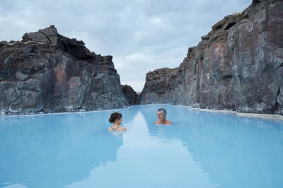 Een brug over het azuurblauwe water van de Blue Lagoon Spa.