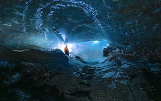 A visitor standing in an ice cave of Langjokull Glacier.