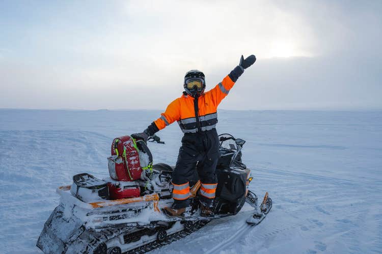 A snowmobile rider says hello for a photo during a guided tour in Iceland.