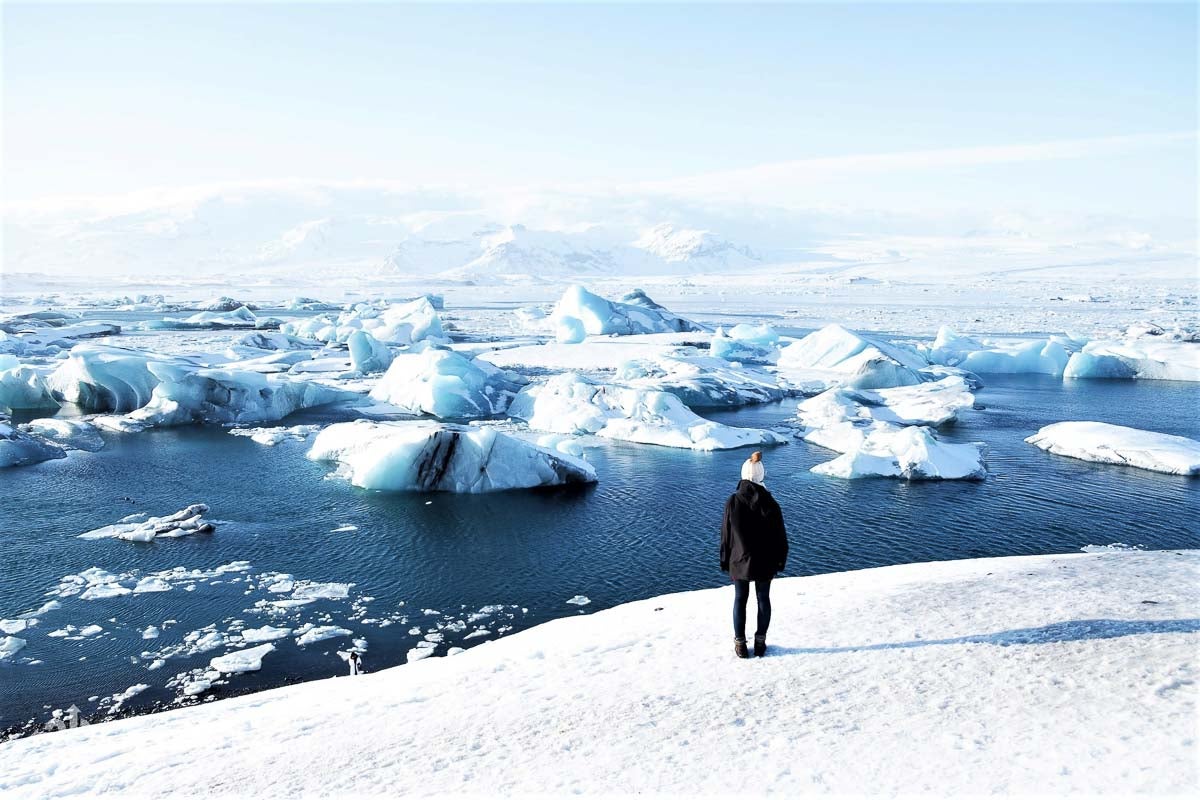 Floating icebergs in Jokulsarlon Glacier Lagoon with Vatnajokull Glacier in the background.