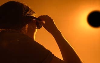 A traveler enjoying the views of a total solar eclipse.