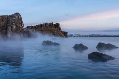 The Sky Lagoon is surrounded by lava rocks and the beautiful coast of Kopavogur.