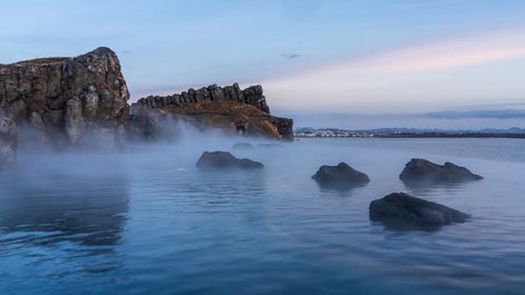 The Sky Lagoon is surrounded by lava rocks and the beautiful coast of Kopavogur.