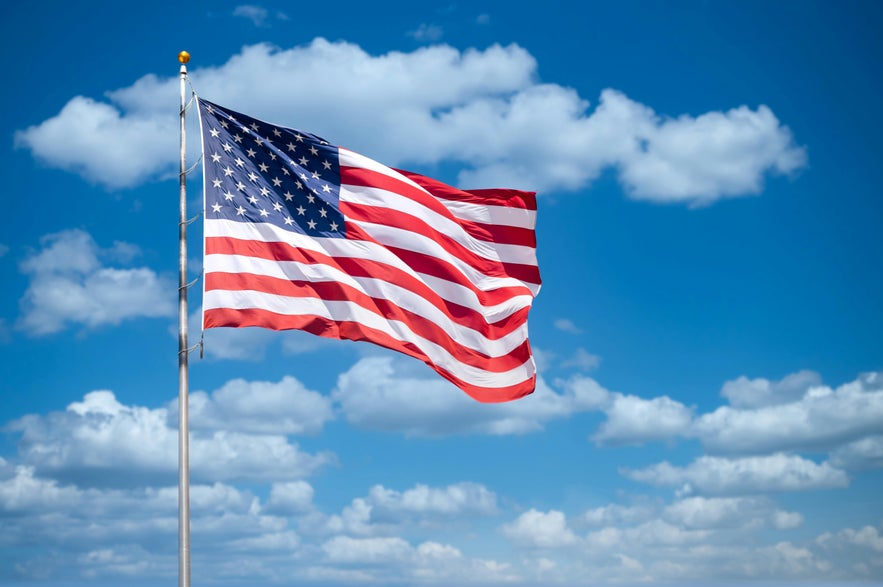 USA flag on blue sky · Free Stock Photo