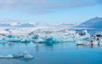 The Jokulsarlon Glacier Lagoon in Iceland is filled with icebergs that shimmer in the sunlight.