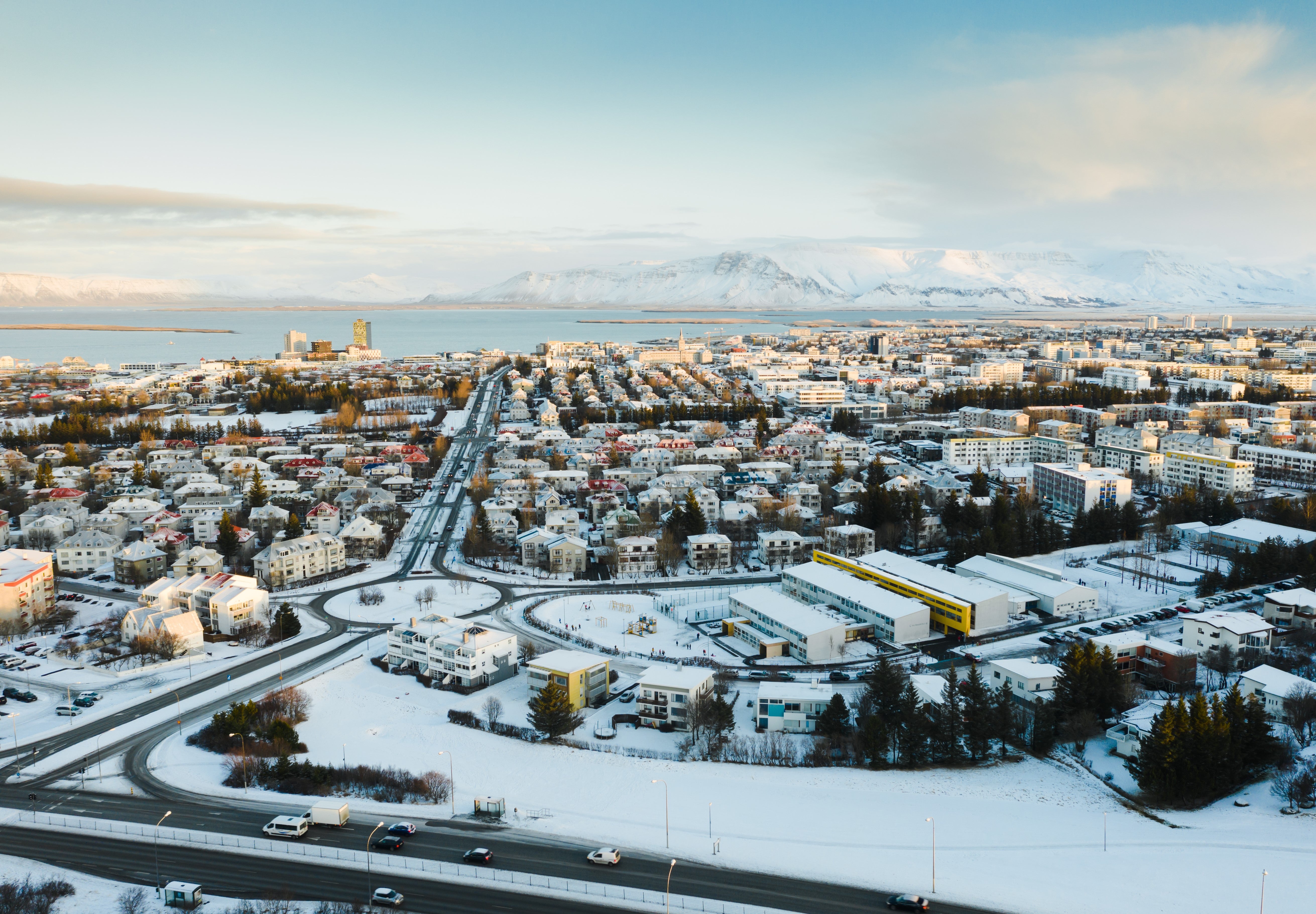 A view of Reykjavik and its surrounding mountains under a blanket of snow.