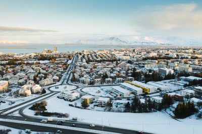 A view of Reykjavik and its surrounding mountains under a blanket of snow.