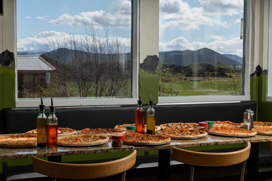 Pizzas spread on a table at Daddi’s Pizza by Lake Myvatn in North Iceland