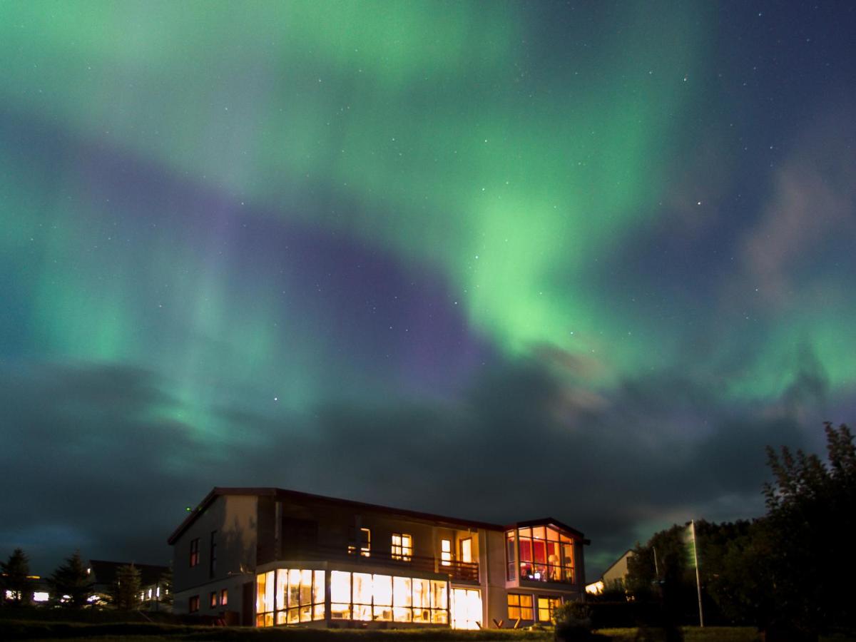 A beautiful display of aurora illuminates the winter skies above Stora-Mork Guesthouse in South Iceland.