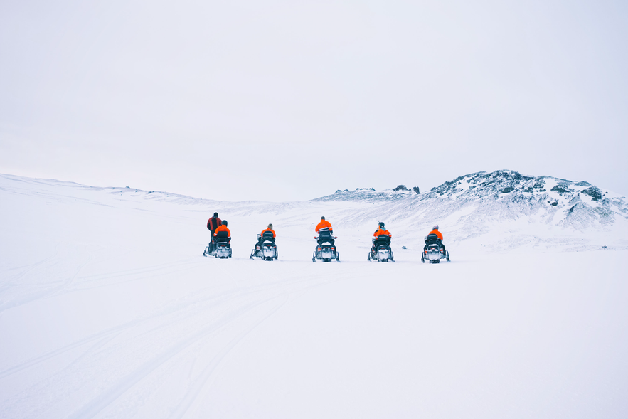 Snowmobilers traverse the glacier