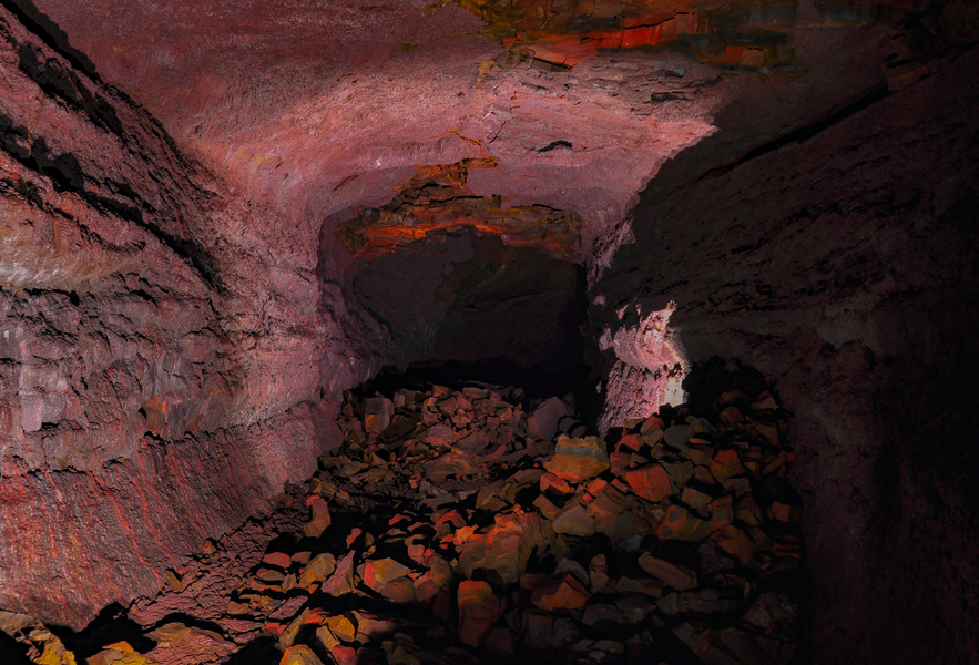 The rich red walls of Vidgelmir lava cave