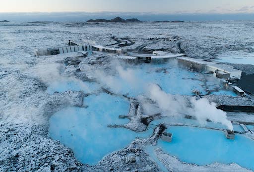 Aerial view of Blue Lagoon surrounded by lava fields in winter.