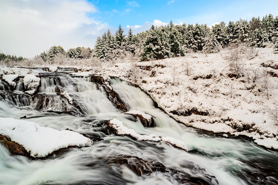 The Kermoafoss Waterfall during winter in Ellidaardalur Valley in Reykjavik, Iceland.