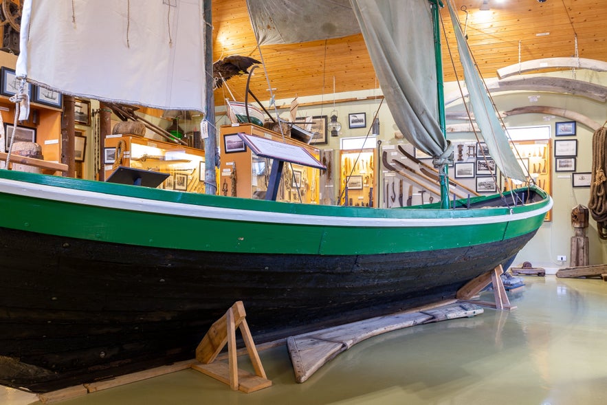 Traditional Icelandic fishing boat displayed inside Hnjotur Museum in the Westfjords.