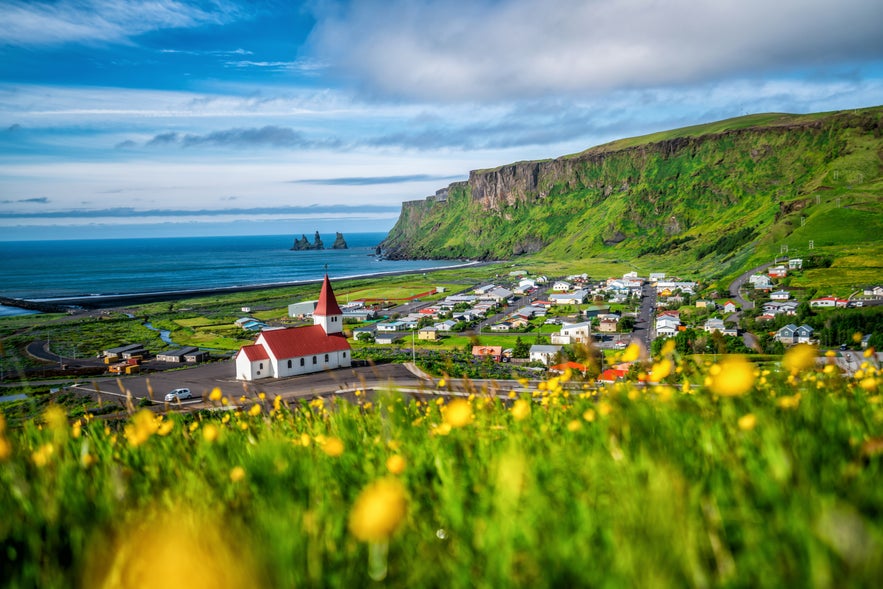 The scenic viewpoint of Vik i Myrdal Church and surrounding landscape taken from the hilltop graveyard behind it.