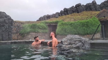 Two men relaxing in the Sky Lagoon geothermal spa near Reykjavik.