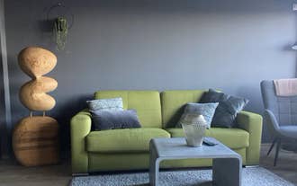 Modern living room with yellow sofa at TB24 Apartments in Akureyri.