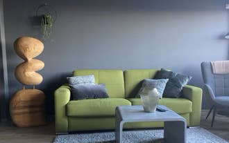 Modern living room with yellow sofa at TB24 Apartments in Akureyri.
