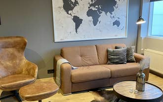The leather sofa and world map artwork create a cozy corner in the Lovely apartment with hot tub access.
