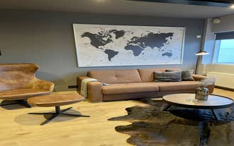 The leather sofa and world map artwork create a cozy corner in the Lovely apartment with hot tub access.