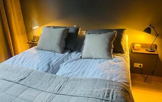 A dark and inviting bedroom with soft lighting from bedside lamps at AK-Lux101 in Akureyri.