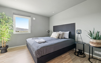 The Serene Summerhouse Near Selfoss offers a cozy double bedroom with countryside views and gray bedding.