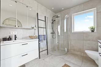 Ванная комната в Serene Summerhouse рядом с Сельфоссом оборудована душевой кабиной и стильной чёрной сантехникой.