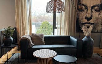 Stylish living room with a large sofa, a coffee table, and abstract art at AK-Lux201 Apartment in Akureyri.