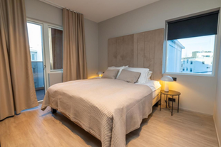 Bedroom with queen-sized bed at Luxury Apartment in Central Akureyri.