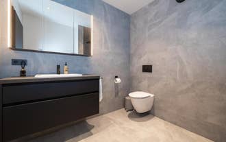 Bathroom at Luxury Apartment in Central Akureyri with modern vanity and toilet.