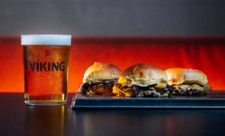 Cheeseburgers with caramelized onions are paired with Icelandic lager at Brixton.