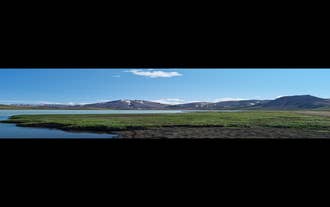 A lovely view of a lake with a stunning mountainous backdrop.