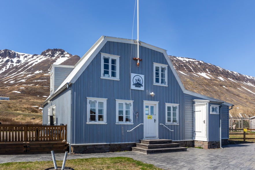 Exterior of the Sudavik Arctic Fox Center with mountain backdrop in Westfjords, Iceland.