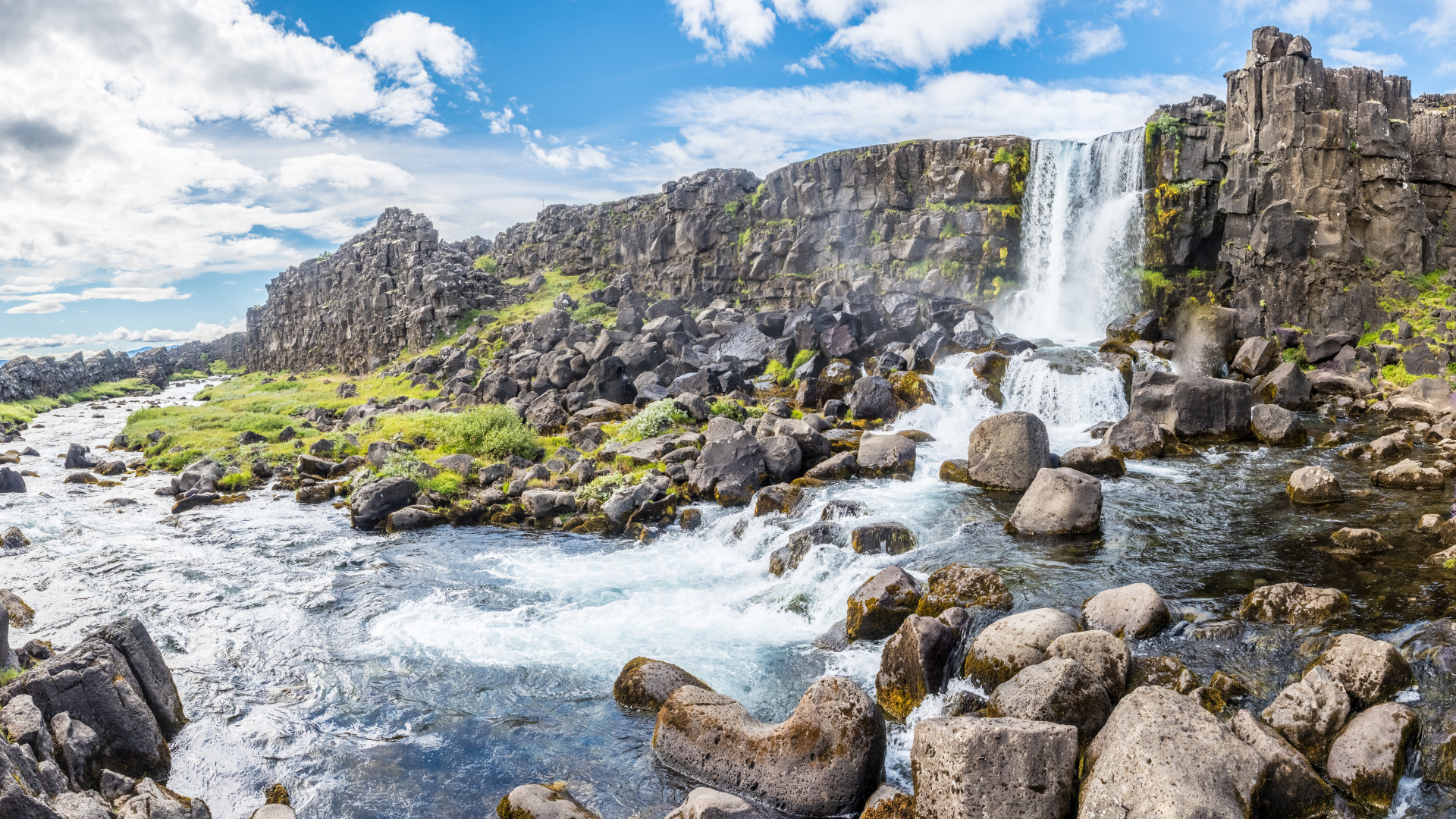 Oxararfoss Waterfall flowing over basalt cliffs in Thingvellir National Park, Iceland.