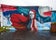 “Melisandre” mural by Natalia Moguel depicting a red-haired woman under a moonlit sky..jpg