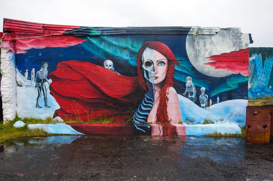 “Melisandre” mural by Natalia Moguel depicting a red-haired woman under a moonlit sky. “Melisandre” mural by Natalia Moguel depicting a red-haired woman under a moonlit sky.
