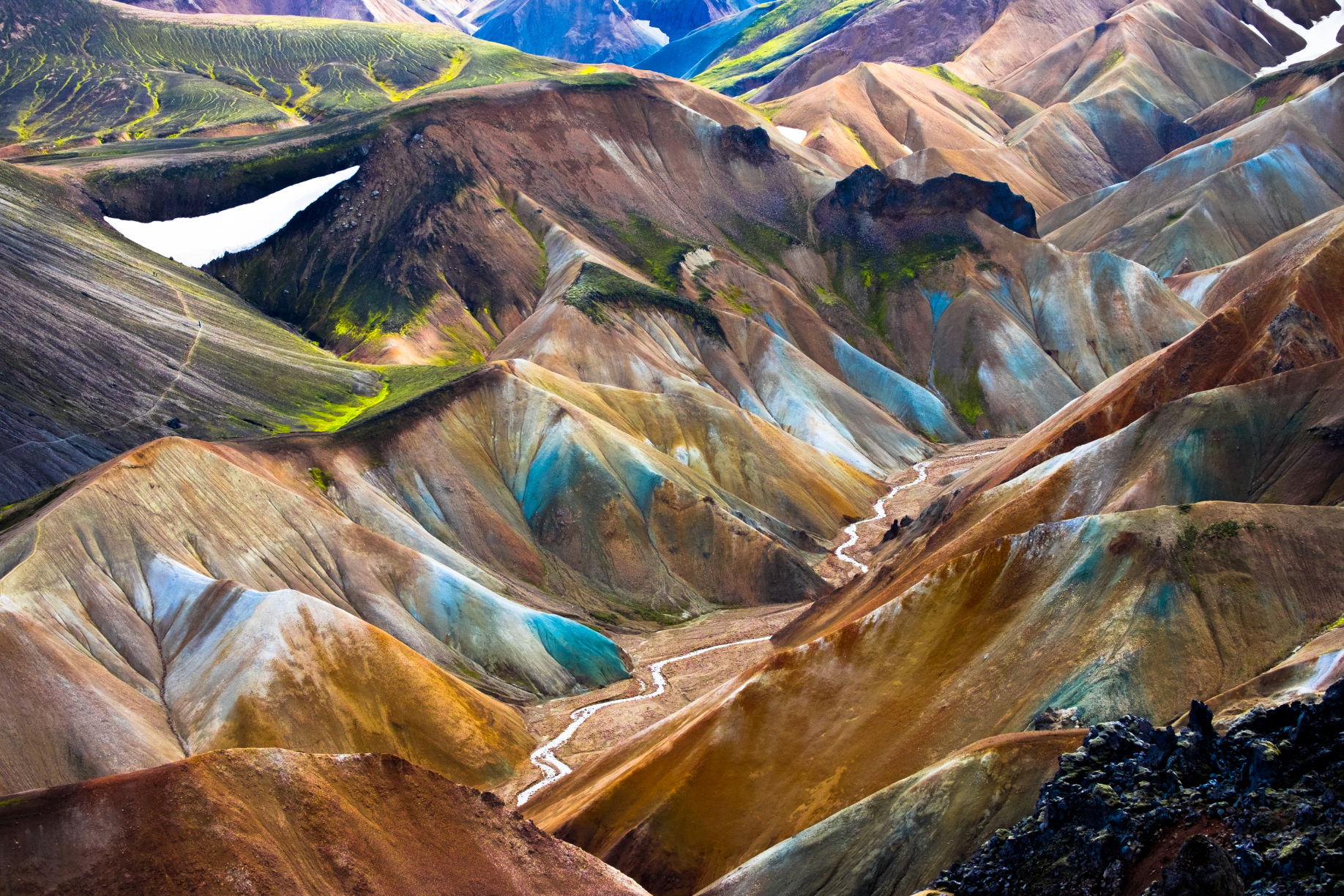 Brightly colored mountains and a winding trail through Landmannalaugar's striking rhyolite landscape.