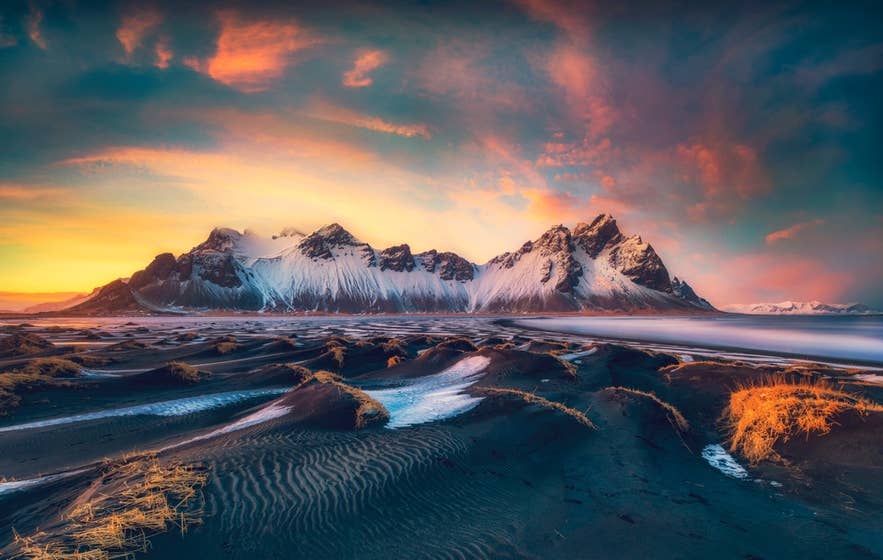 Vestrahorn mountain at sunset rising above the black sand dunes of Stokksnes