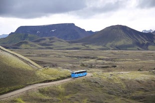 A view of a highland bus crossing a mountain pass in the Icelandic Highlands.