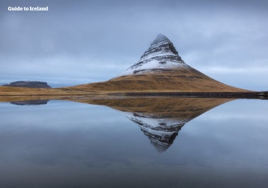 Snow covers the dramatic Mount Kirkjufell.