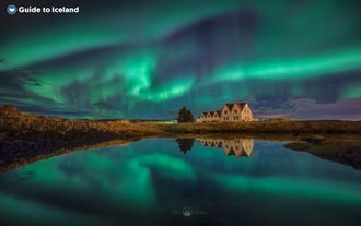 Thingvellir National Park at night, during winter with the northern lights above.