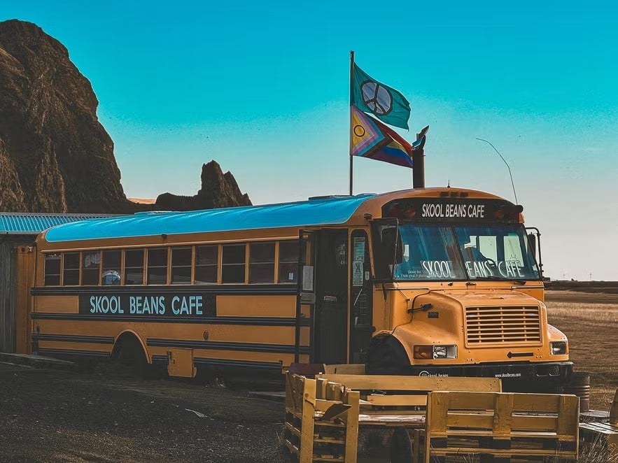 The iconic yellow bus of Skool Beans cafe in Vik, Iceland.